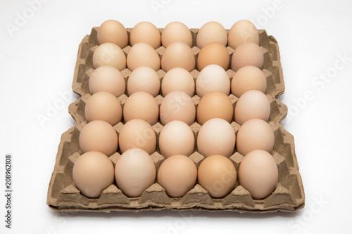 chicken eggs in a cardboard box for eggs isolated on a white background