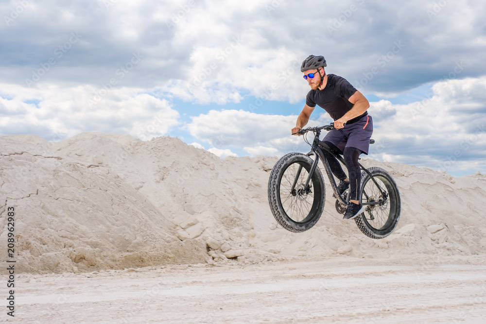 Training a bicyclist in a chalky quarry. A brutal man on a fat bike.