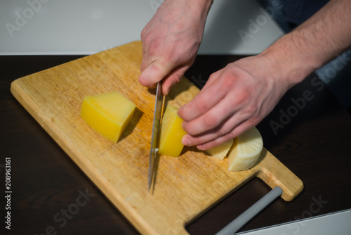 man cuts cheese