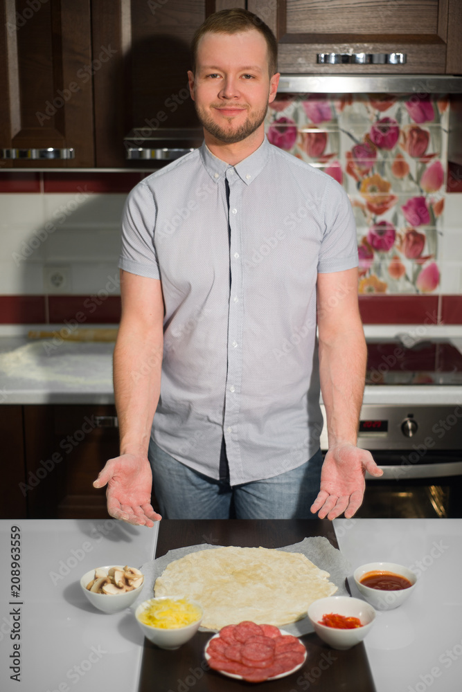 a man shows the ingredients of pizza a man shows the ingredients of pizza