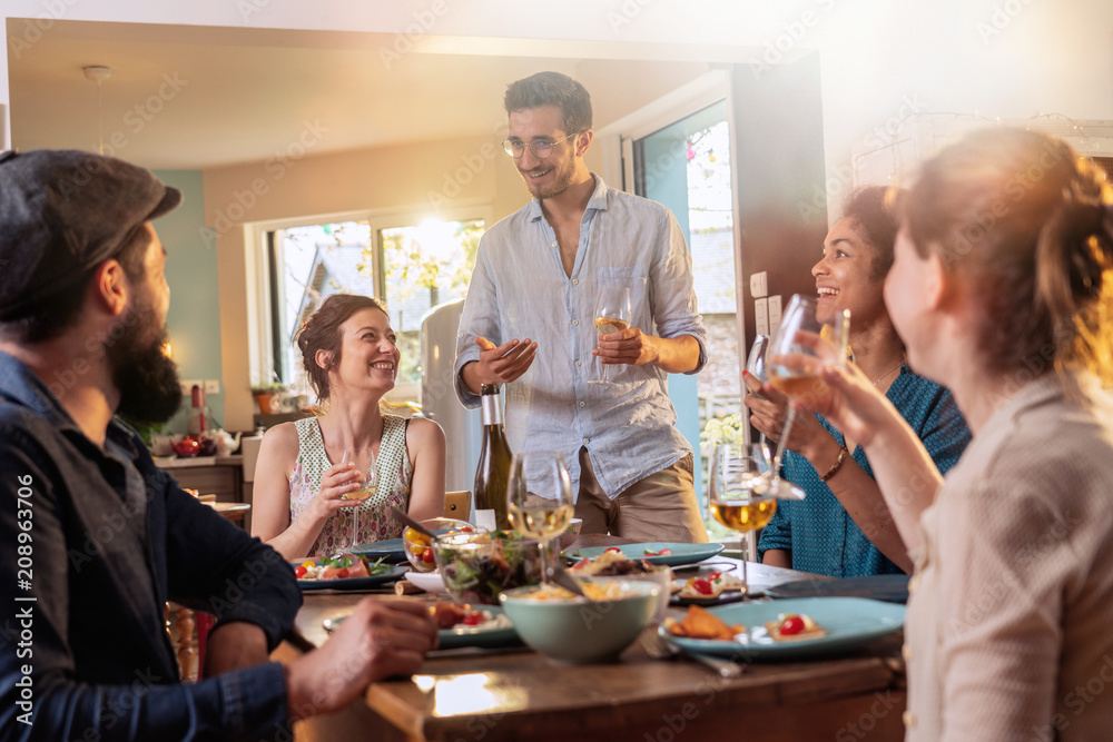 Mixed group of friends having fun while sharing a meal Mixed group of friends having fun while sharing a meal