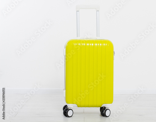 Yellow suitcase isolated on white background Fototapeta
