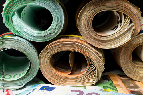 фотографія Rolled several thousand euro banknotes with rubbers