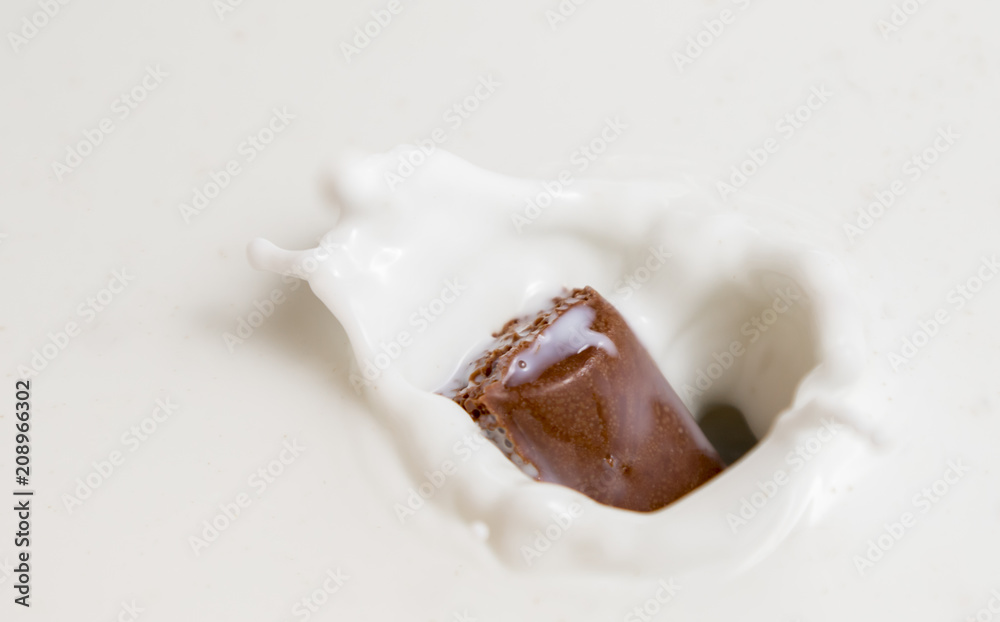 Chocolate falls in milk