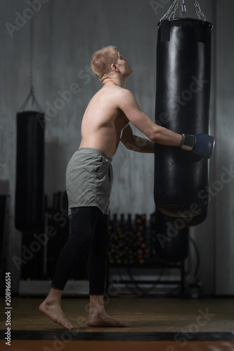 Young boxer training with punching bag