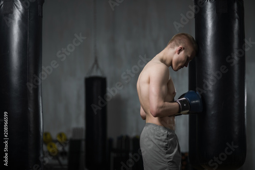 Young boxer training with punching bag