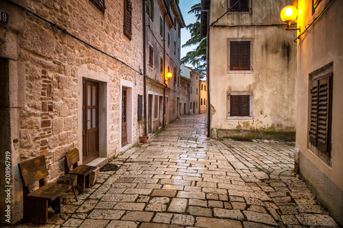 Street in Porec town illuminated by lamps at the evening, Croatia, Europe.
