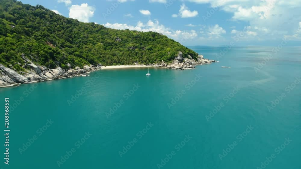 flying over amazing white sand beach and tropical lagoon with yacht flying over amazing white sand beach and tropical lagoon with yacht