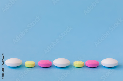 Medication  colourful pills  flat lay on blue background