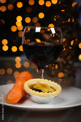 Mince pie, carrot and glass of port left on a plate on Christmas Eve for Santa Claus and Rudolph photo