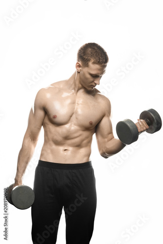 young bodybuilder lifts weights on a white background