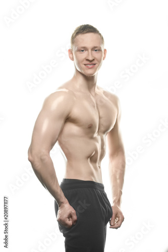 beautiful bodybuilder shows off tense body on white background