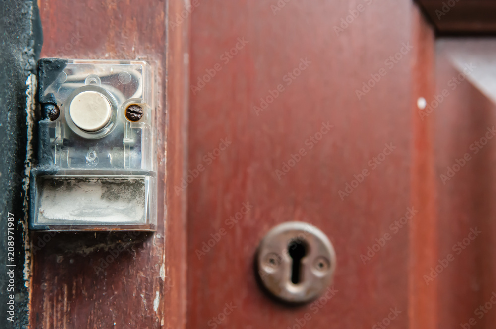 Push button door bell on a door frame