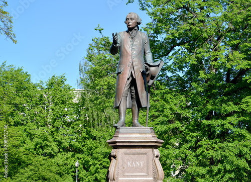 Monument to Immanuel Kant against the background of young foliage. Kaliningrad