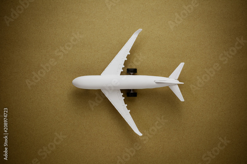 Model airplane on old paper background.
