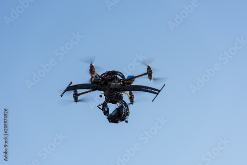 Heavy drone with professional cinema camera flying photo