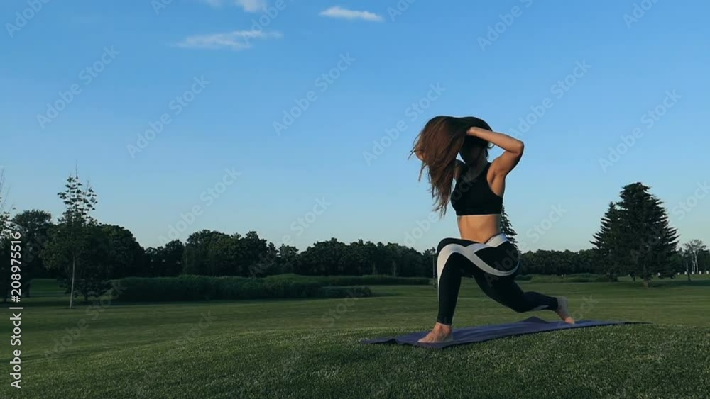 Woman trainig nad stretching outdoors. Slow motion. Woman trainig nad stretching outdoors. Slow motion.