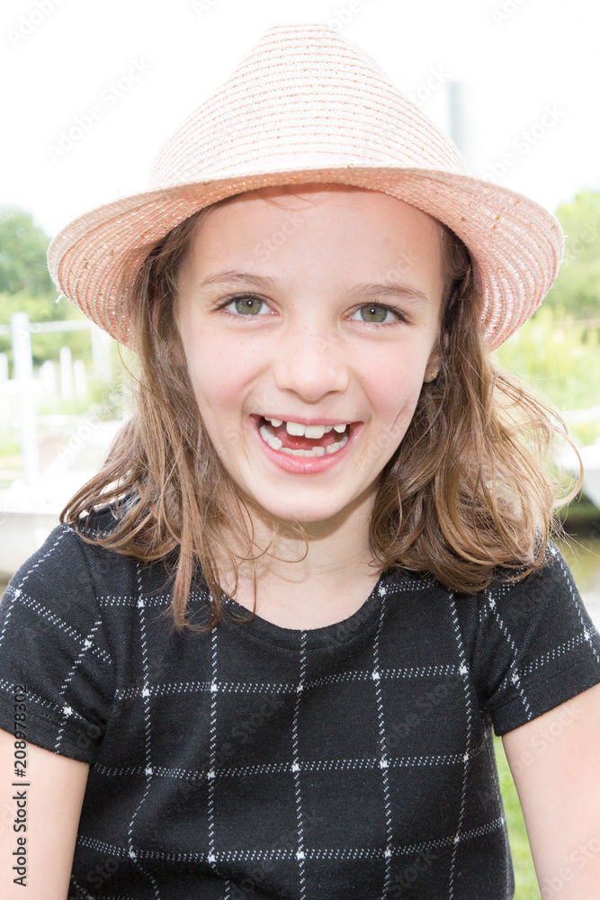cute happy young hat girl smiling in summer