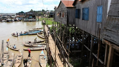 Fisherman boats are starting to sail on a river from a wood village in Cambodia MF