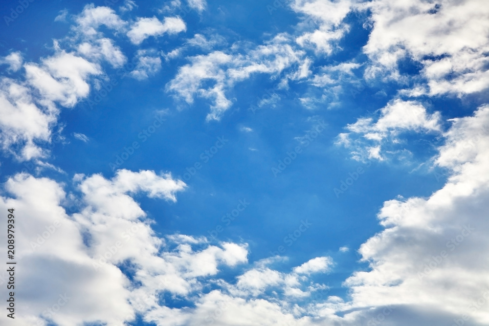 white fluffy soaring clouds on a blue sky background white fluffy soaring clouds on a blue sky background
