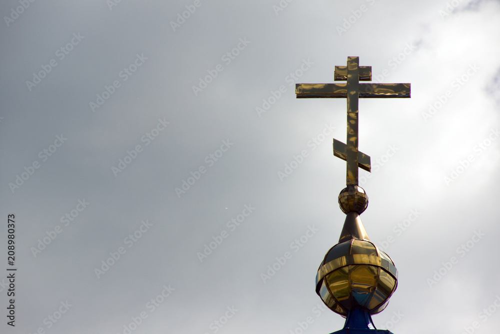 Golden cross of Russian orthodox church on blue sky background Golden cross of Russian orthodox church on blue sky background