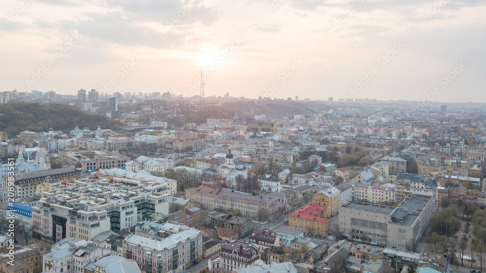 The panoramic bird's eye view from drone to the central historical part of Kiev, Ukraine - the Podol district, the district of Dorohozhychi at summer sunset.