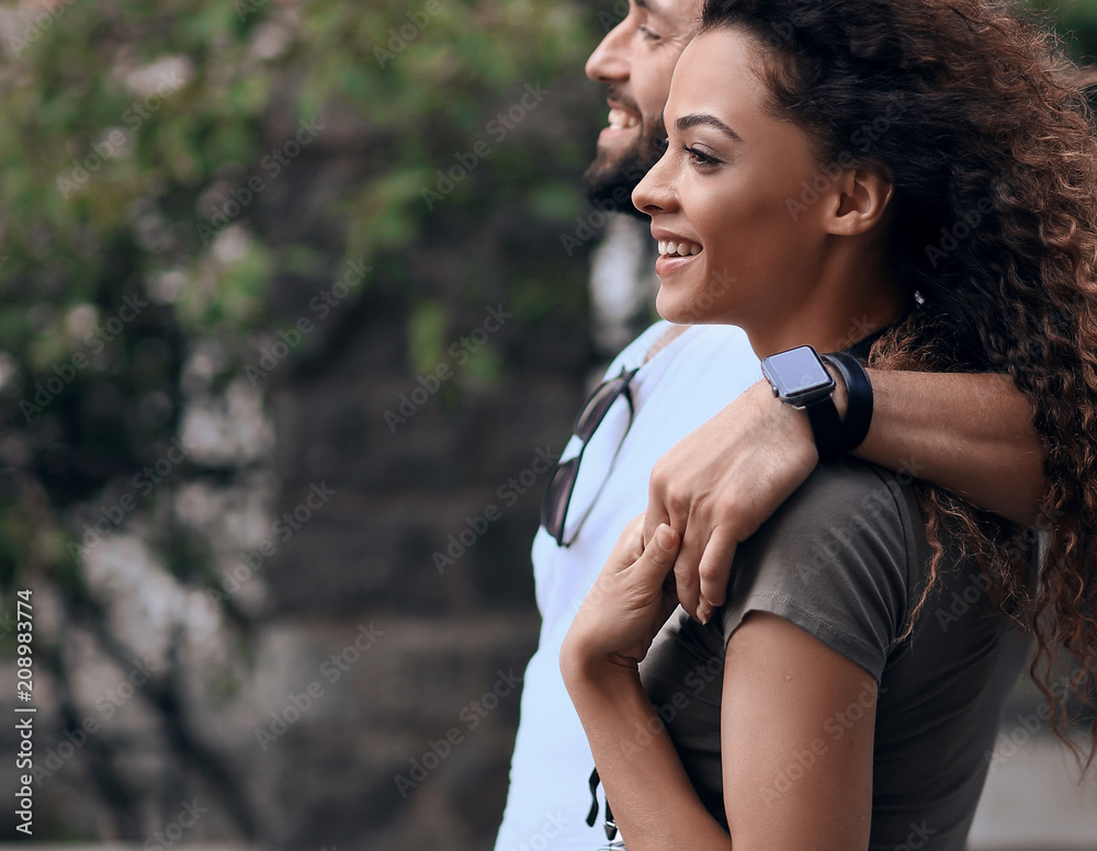 Cheerful young couple walking on urban street Cheerful young couple walking on urban street