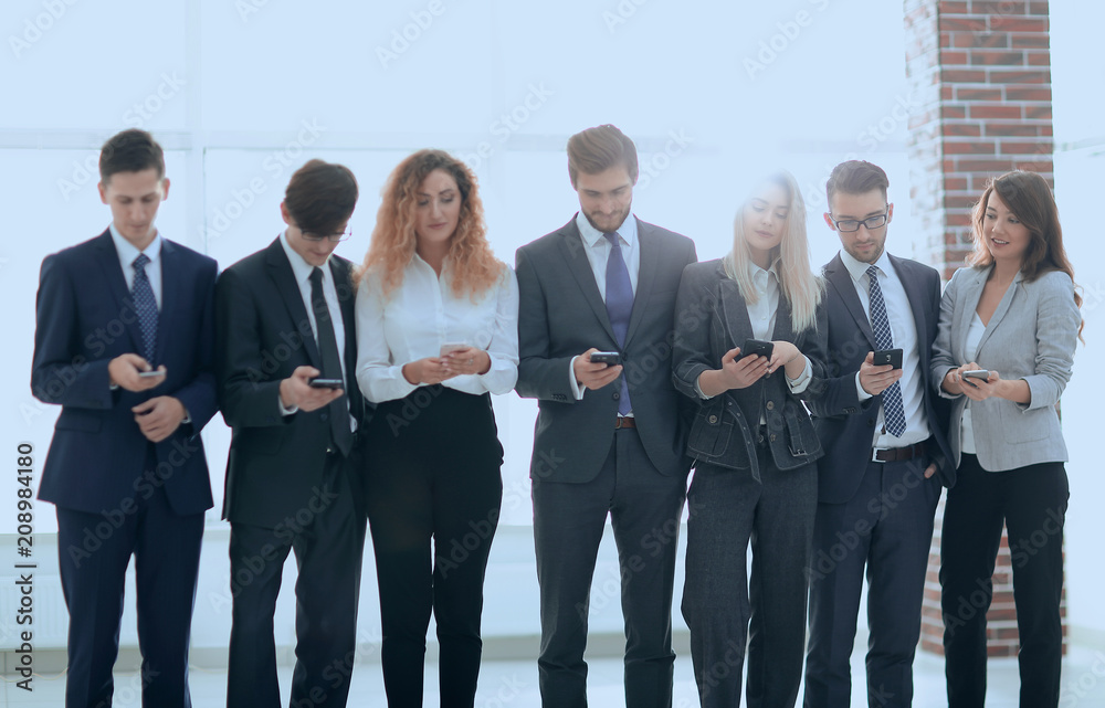 business team looking to smartphone in office business team looking to smartphone in office