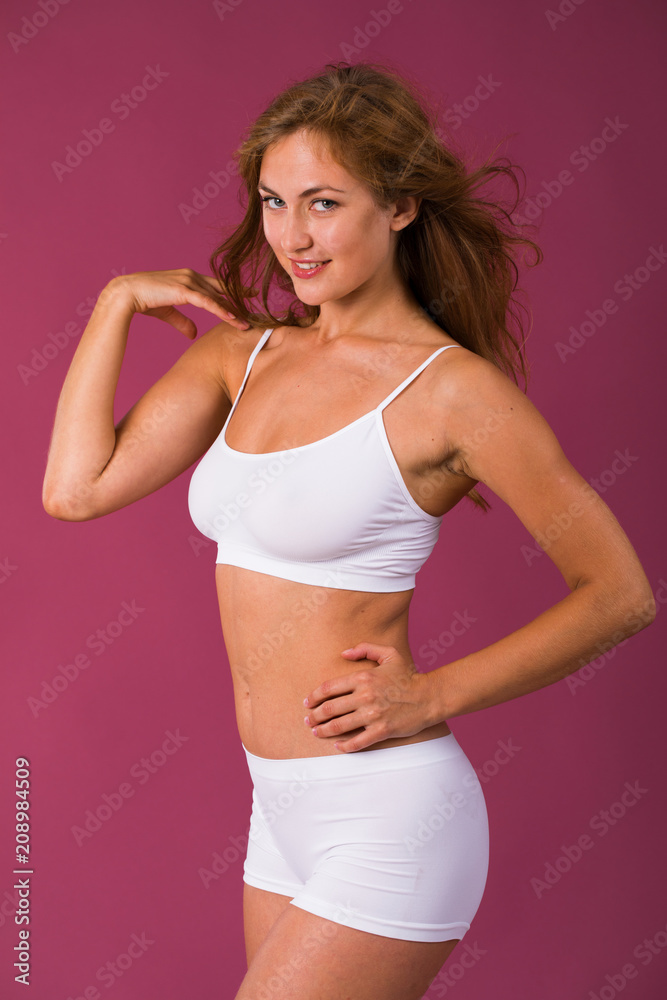 Young beautiful blonde woman in white fitness clothing Young beautiful blonde woman in white fitness clothing