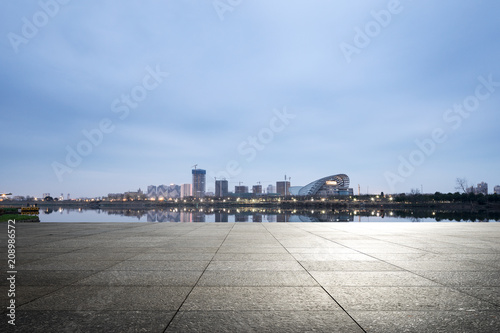 empty ground with modern city skyline © zhu difeng
