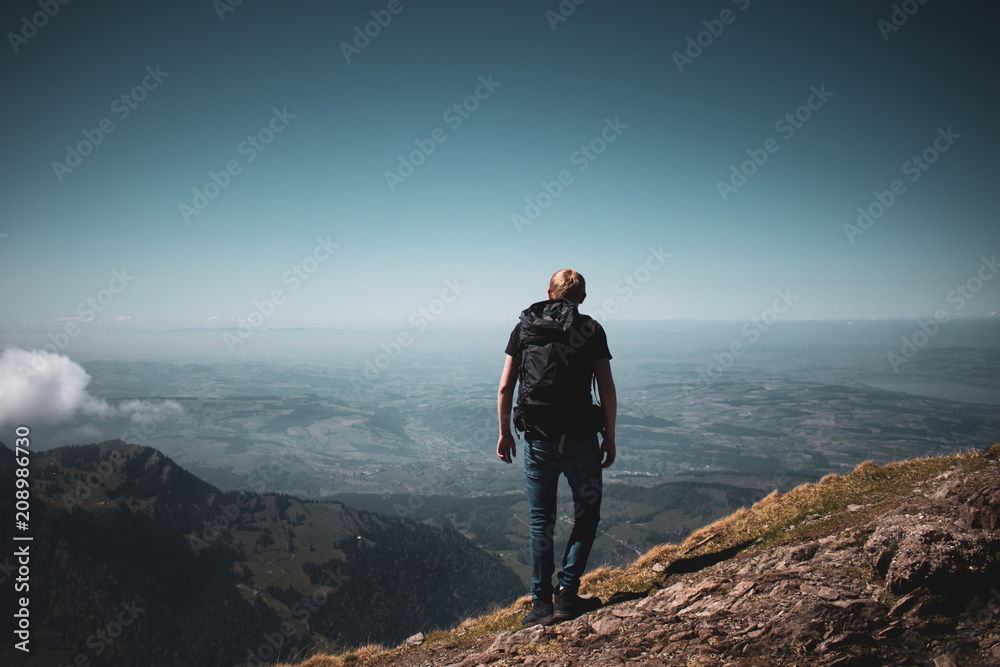 adventurer reaches the peak of mountain