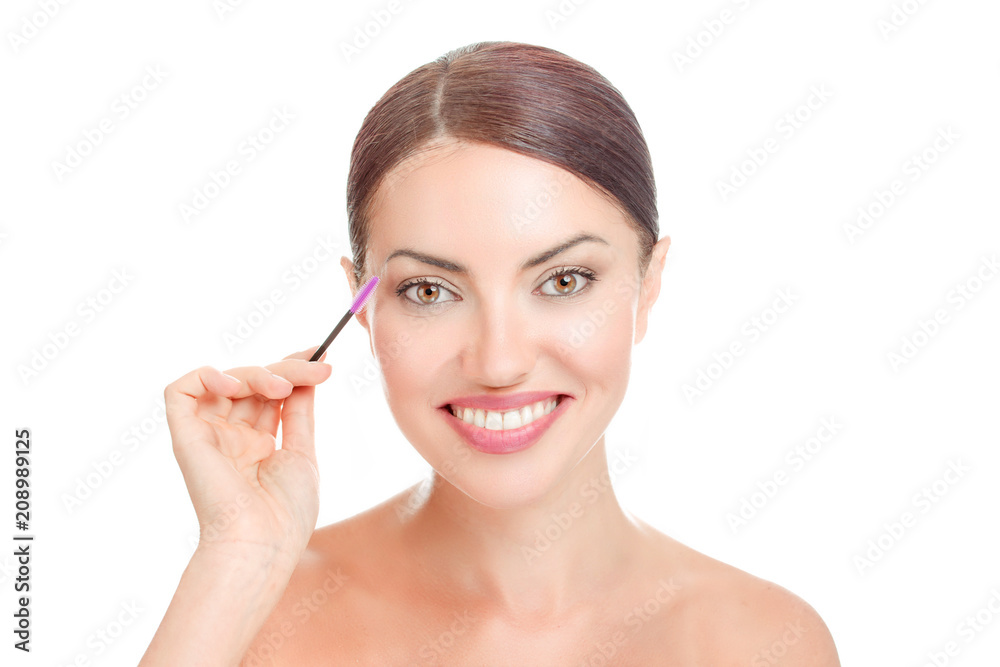woman holding mascara brush near her long eyelashes woman holding mascara brush near her long eyelashes