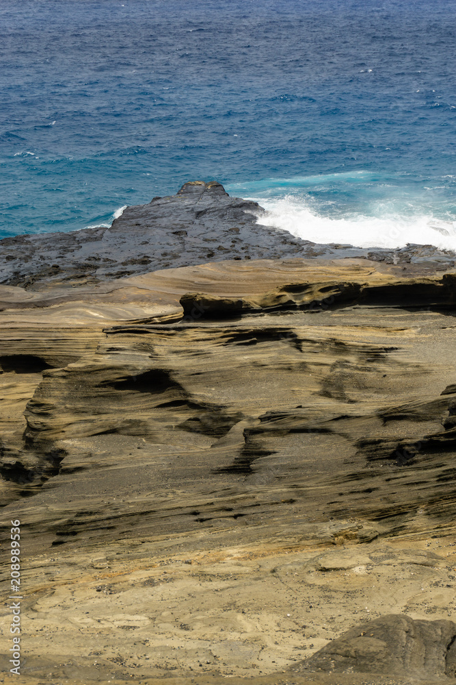 Scenic ocean shore with wave like rock cliffs on Oahu, Hawaii Scenic ocean shore with wave like rock cliffs on Oahu, Hawaii