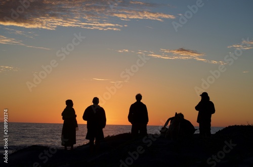 Group of friends watching the sunset