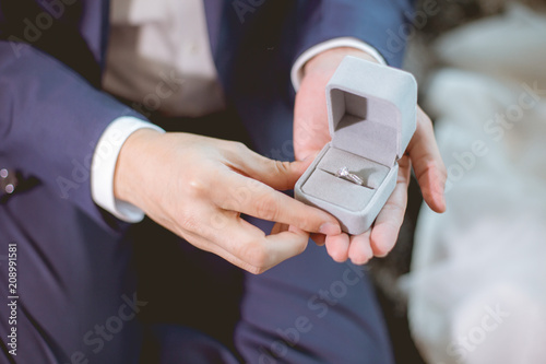 Valokuvatapetti Man open a diamond ring box for marry his girlfriend.