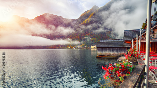 Scenic view of famous Hallstatter lake. Foggy autumn sunrise at Small chinese restaurant near Hallstatt lake