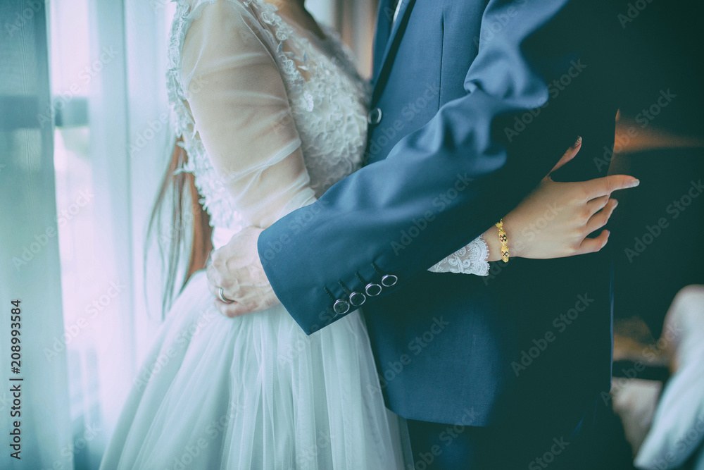 The couple in modestly dress are hugging together.