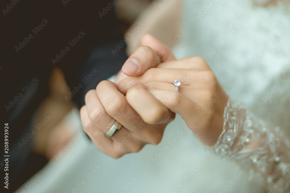 close up couple hands man holding happy fiance hand with diamond engagement  ring on her finger after wedding proposal at tropical beautiful and  romantic spot proposing marriage Stock Photo | Adobe Stock