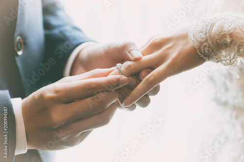 Couple wearing wedding ring at wedding day of them.