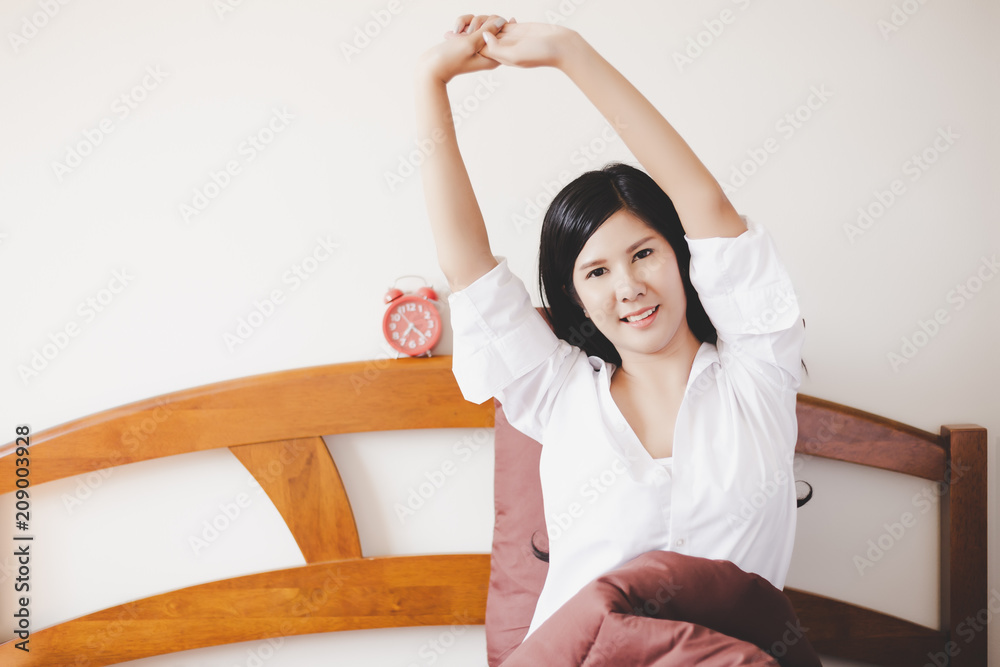 Portrait charming beautiful woman. Attractive beautiful girl is waking up in the morning and stretching her arms and body. Gorgeous girl sleep very well all night. She gets happy, active. copy space