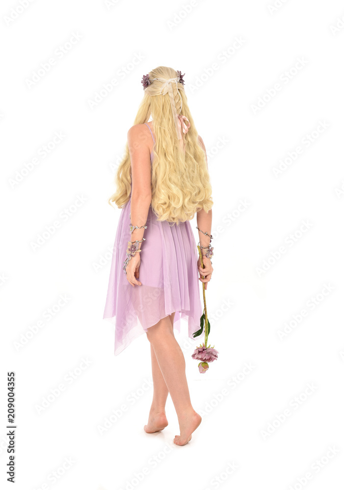 full length portrait of blonde fairy girl, holding flowers. standing pose on white studio background. full length portrait of blonde fairy girl, holding flowers. standing pose on white studio background.