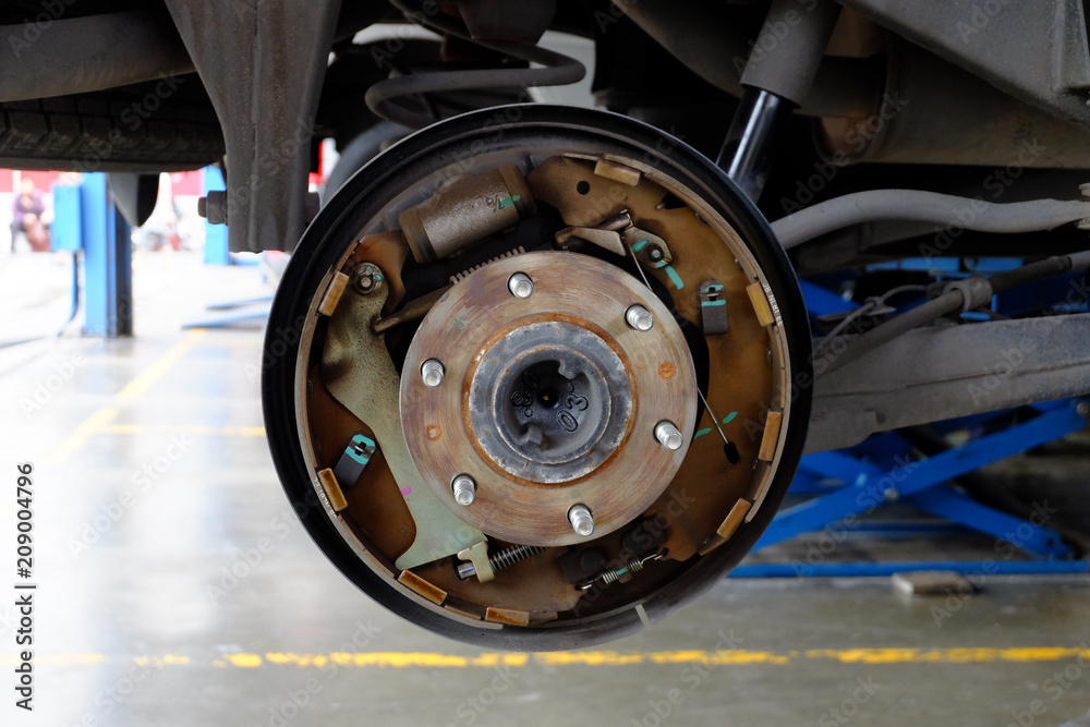 Disc break of car in process to new replacement. Car repairing shop. Disc break of car in process to new replacement. Car repairing shop.