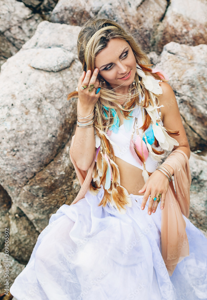 beautiful young boho style woman in white dress on stone beach beautiful young boho style woman in white dress on stone beach
