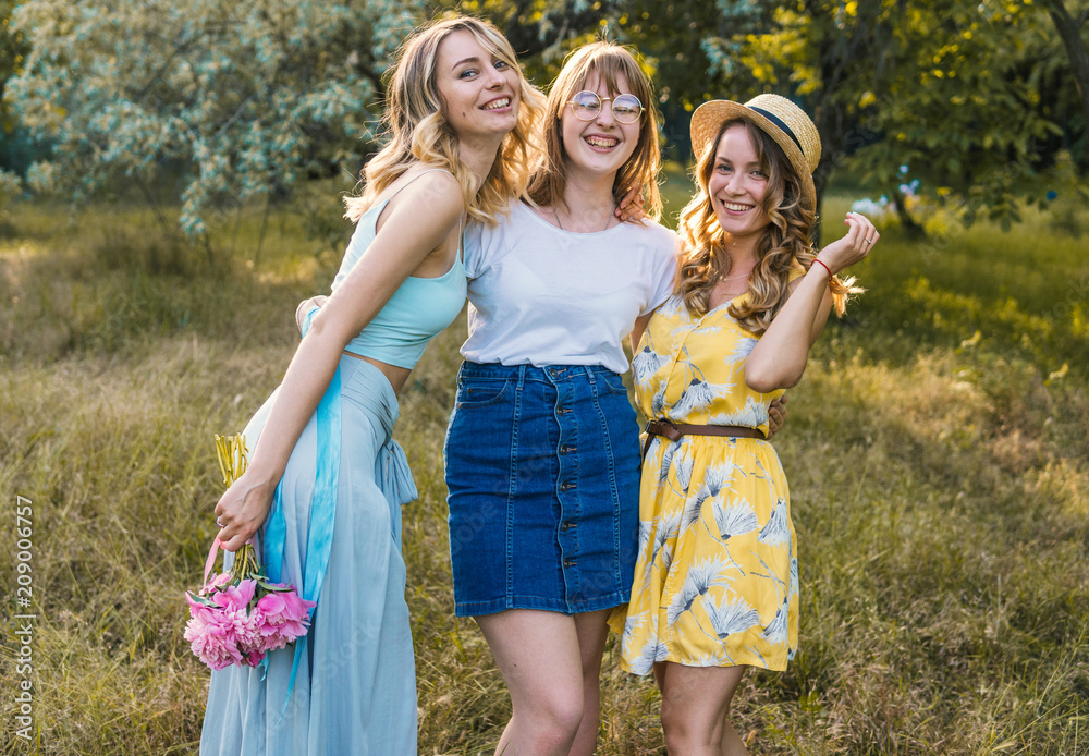 Fototapeta premium Three girls friends outdoor in the park or forest. bachelorette, party
