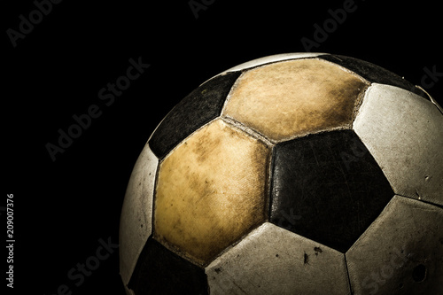 Close up of Old Soccer ball on black background