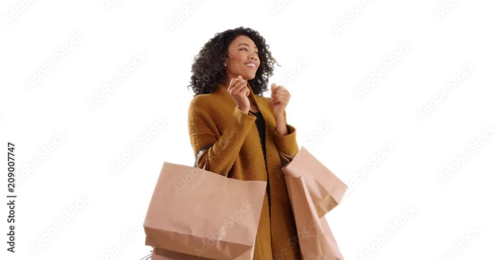 Beautiful African woman dancing with shopping bags on white background with copyspace, Portrait of happy black female celebrating new purchases smiling in studio, 4k Beautiful African woman dancing with shopping bags on white background with copyspace, Portrait of happy black female celebrating new purchases smiling in studio, 4k