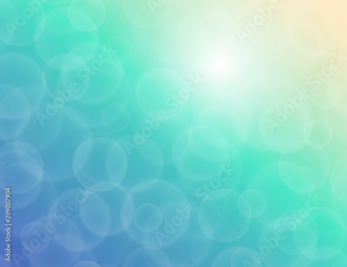 Vector bokeh texture on a bright two-tone blue-green background. Festive abstract blur background.