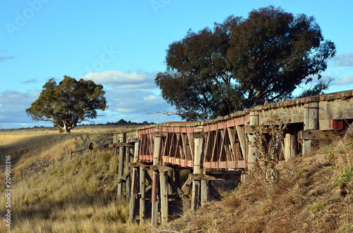 Old abandoned wooden railway bridge over the Boorowa River, in rural central west NSW, Australia