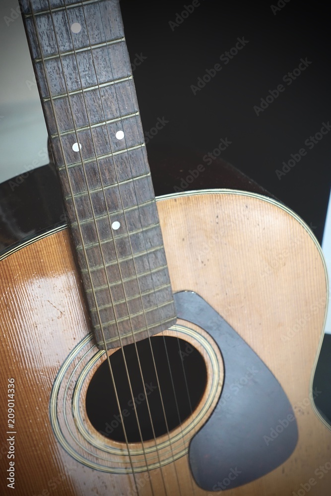Close up of old Acoustic Guitar with very shallow depth of field, focus on strings.