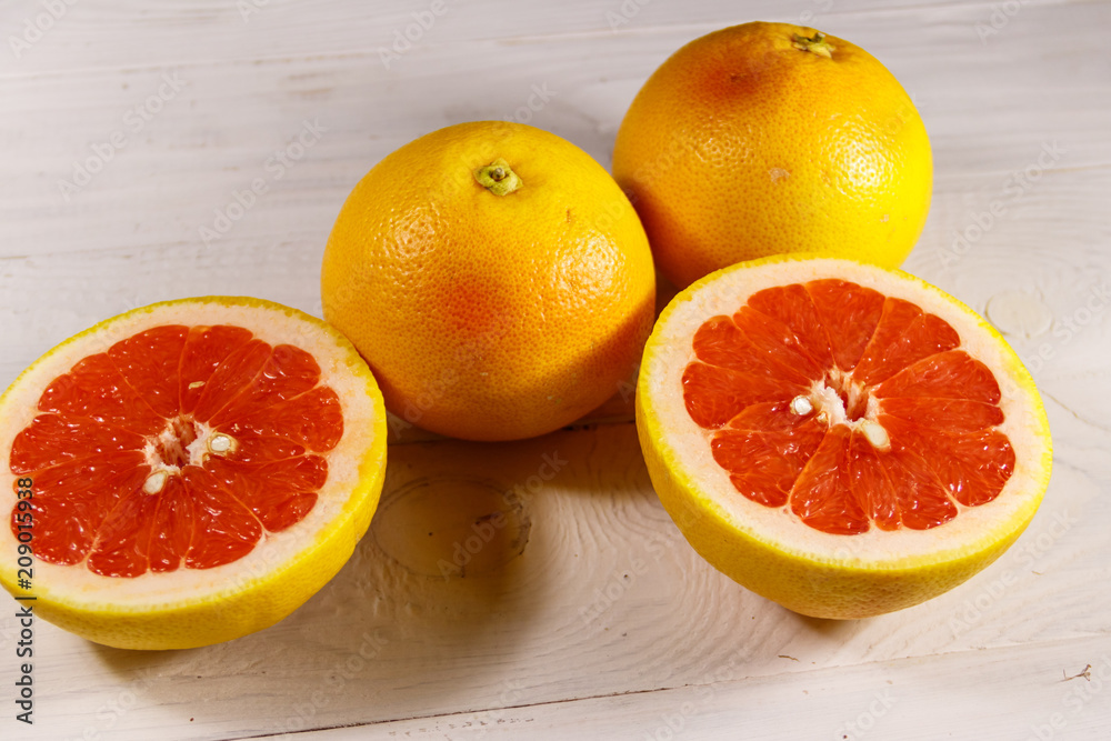Ripe fresh grapefruits on white wooden table Ripe fresh grapefruits on white wooden table